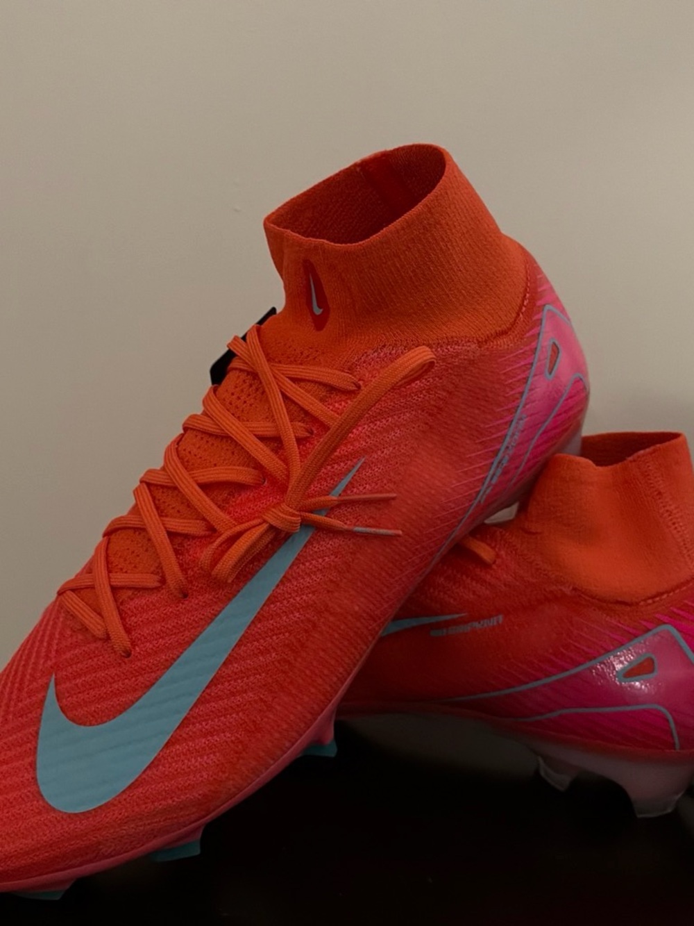 Nike Kids Orange Soccer Cleats with Light Blue Swoosh